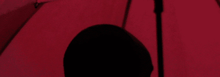 man holding red umbrella