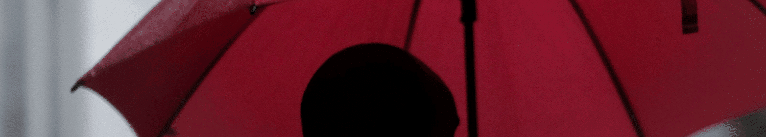 man holding red umbrella